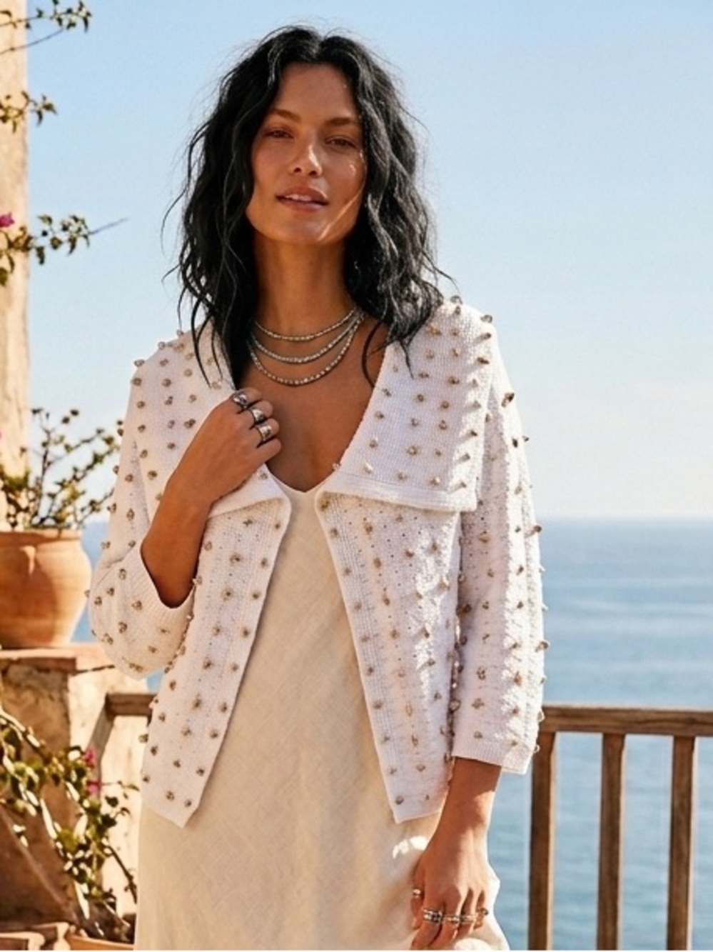 Worth white knit cardigan with shell embellishments.